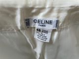a close up of a label on the back of a white dress