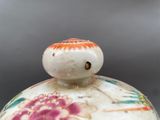 a close up of a vase with a bird on it