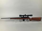 a rifle with a scope mounted on the side of it