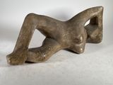 an image of a sculpture of a woman laying on her back