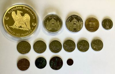 several different coins are arranged in a row on a white surface