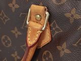 a close up of a brown louis vuitton handbag