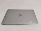 a silver apple laptop sitting on a white surface