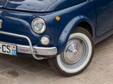 a small blue car parked on the side of the road