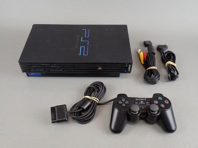 a video game console with a game controller next to it