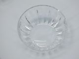 a clear glass bowl on a table with a white background