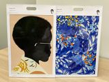 two paintings of a woman with glasses on a table