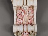 a picture of a decorative wall bracket with a flower design