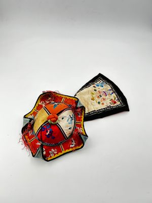 two pieces of cloth on a white surface