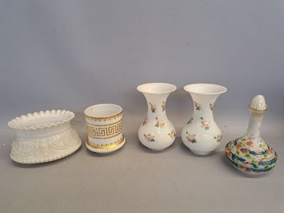 five different vases sitting on a table next to each other