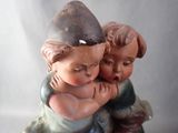a figurine of two children hugging each other