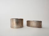 pair of antique silver napkin rings on a white background
