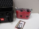 a black case and a red bag sitting on a table