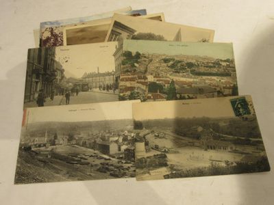 many old postcards of different cities on a table