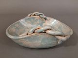 a blue bowl with a knot in it on a table