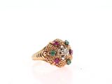 an image of a gold ring with multi colored stones on it