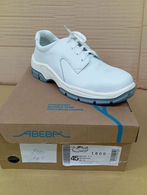 the shoe is white and blue on top of a cardboard box