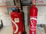 a fire extinguisor and a fire hose on a counter