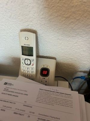a cell phone sitting on top of a table next to a book