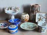 many different types of pottery sitting on a table