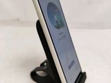 a tablet that is sitting on a stand on a table