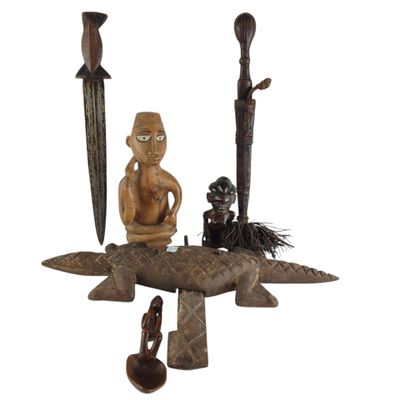 a statue of a man sitting on top of a boat next to other items