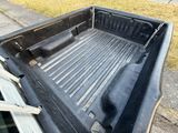 a truck bed that has been left on the side of the road