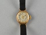 an image of a gold watch with a black strap