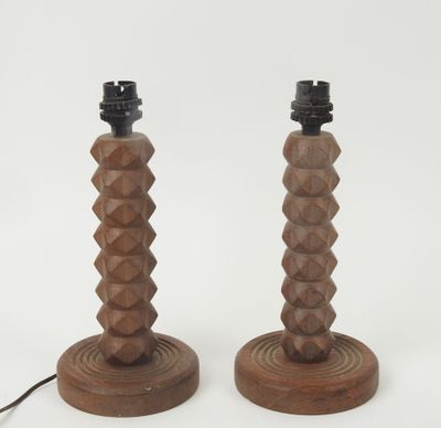 pair of wooden table lamps with geometric designs on the bases