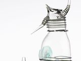 a glass jar with a metal handle and a glass jar with a glass lid