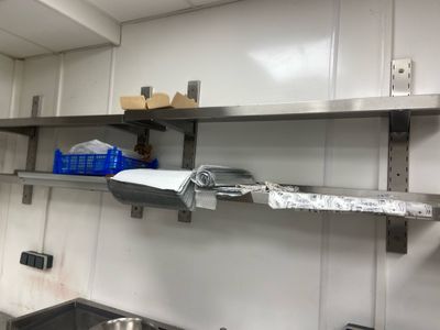 a metal shelf that has some items on it