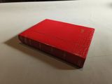 a red book sitting on a white table