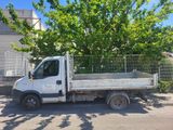 a white truck parked in front of a tree