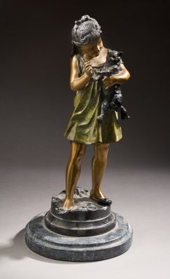 bronze statue of a young girl holding a cat on a pedestal