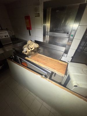 a kitchen with a stove, sink, and oven in it