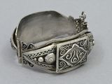 an image of a silver ring with a decorative design on it