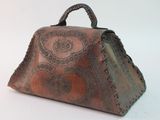 a brown purse with a handle on a white surface