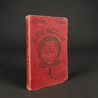 a red book with a picture of a woman ' s name on it