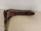 an old rusty pipe cutter on the floor next to a wall