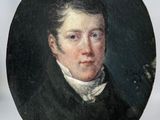 portrait of a young man in a black coat and white shirt