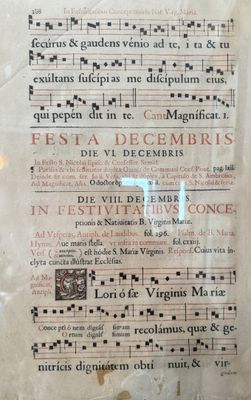 an old book with a page of music written on it