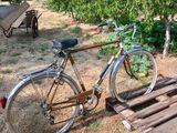 a bike that is parked next to a wooden pallet