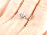 an image of a woman ' s hand with a diamond ring on it