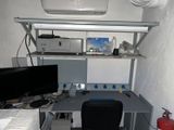 a desk with a computer and a monitor in a room