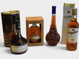 several different types of liquor bottles and cans on a white surface