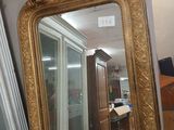 a mirror that is sitting on a table in a room