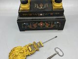 pair of antique black and gold candlesticks with a key