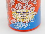 an orange and blue container with a flower design on it