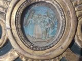 a gold frame with a picture of a man and a woman on it