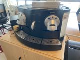 a coffee machine sitting on top of a wooden table